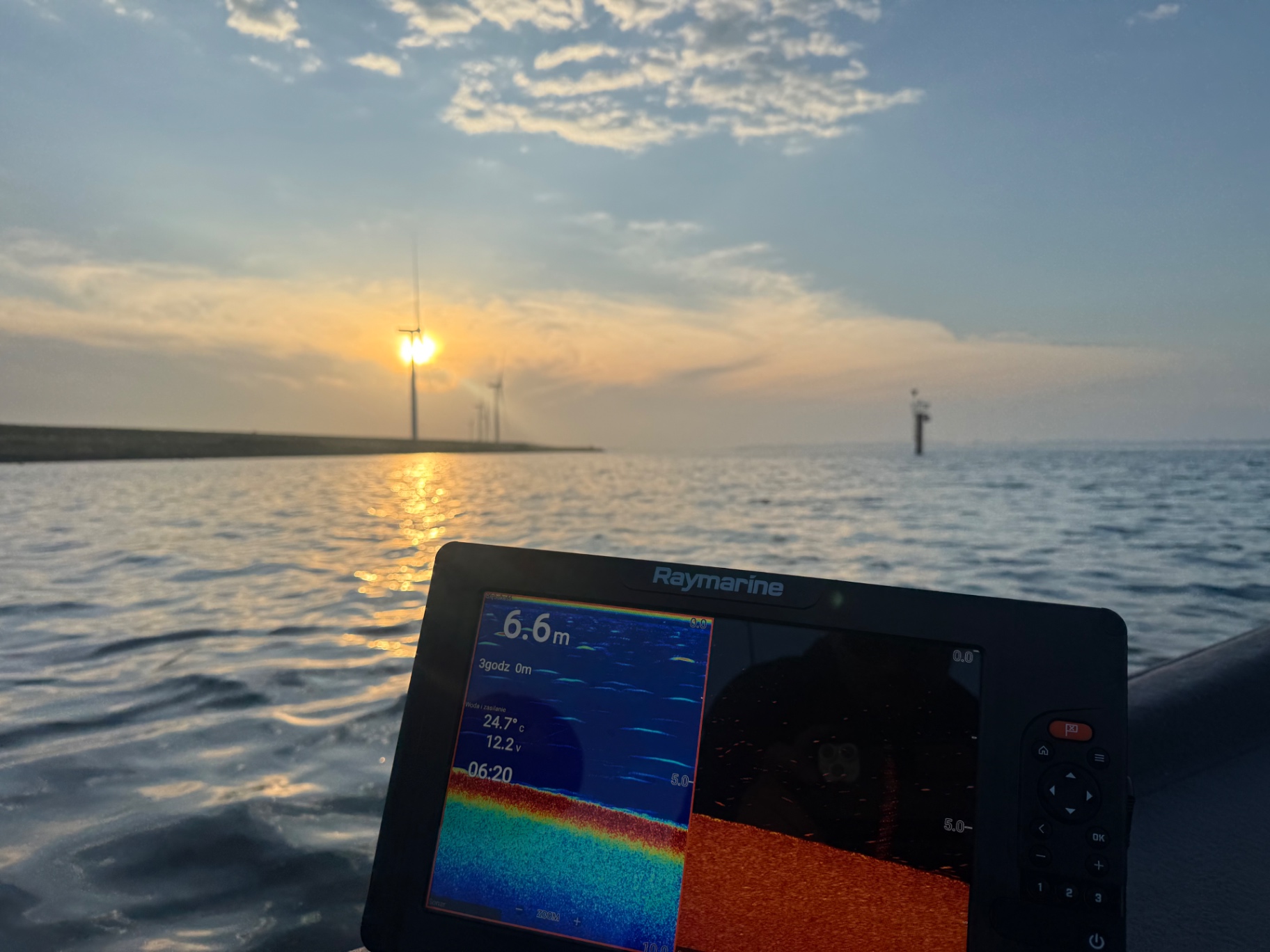 Angler casting from a Ryds fishing boat at sunrise on the waters of Zuid-Holland