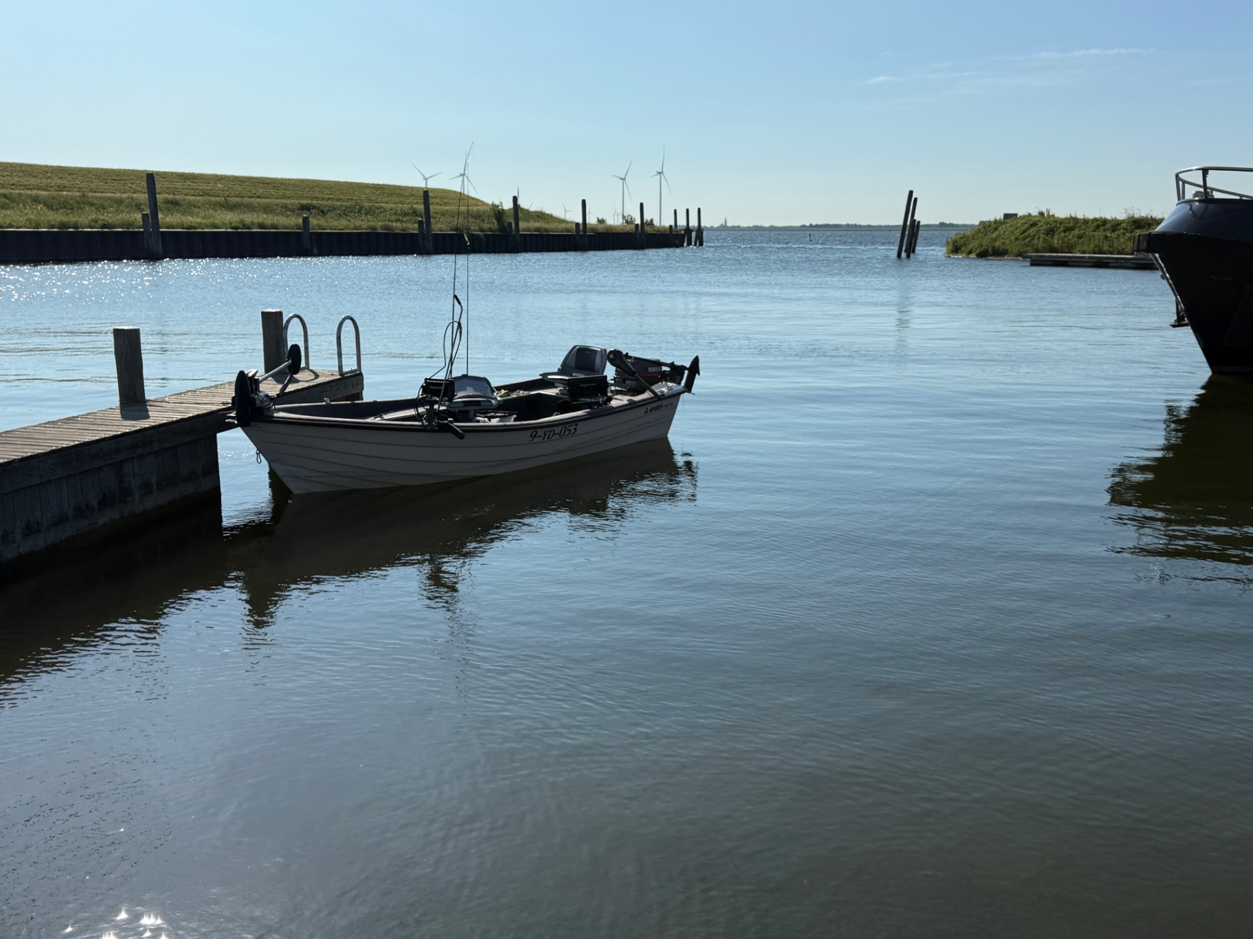 Ryds 465 aluminum fishing boat with Honda 25 HP outboard on calm water